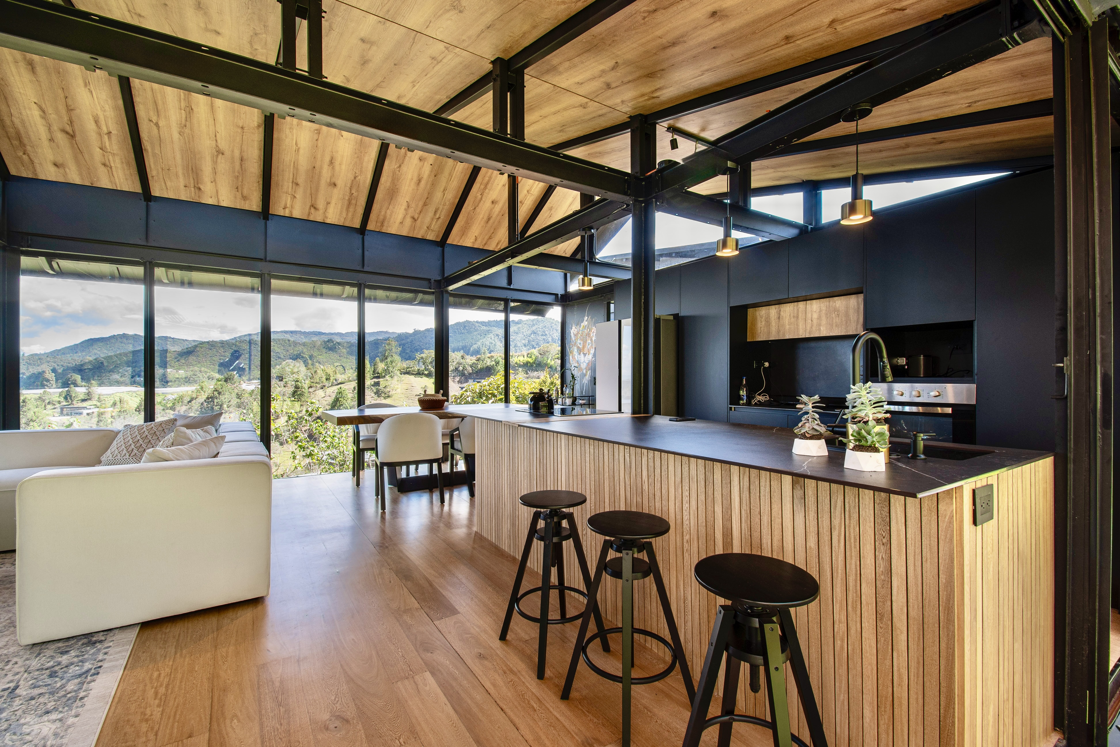 Kitchen island and dining area with full-height garden windows