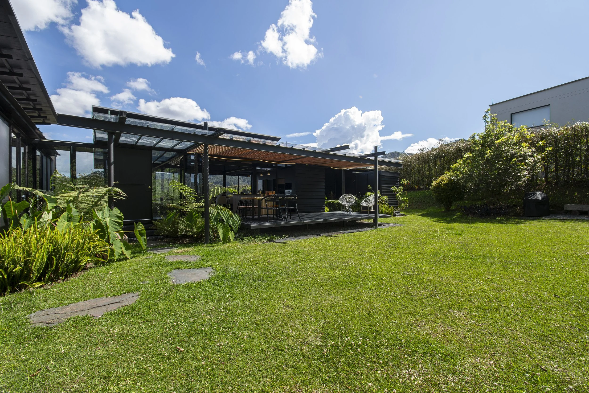 House and covered terrace viewed across the lawn