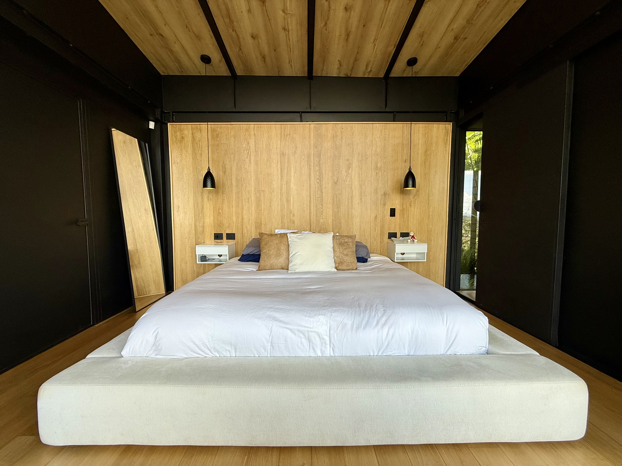 Bedroom with a timber headboard and a white bed