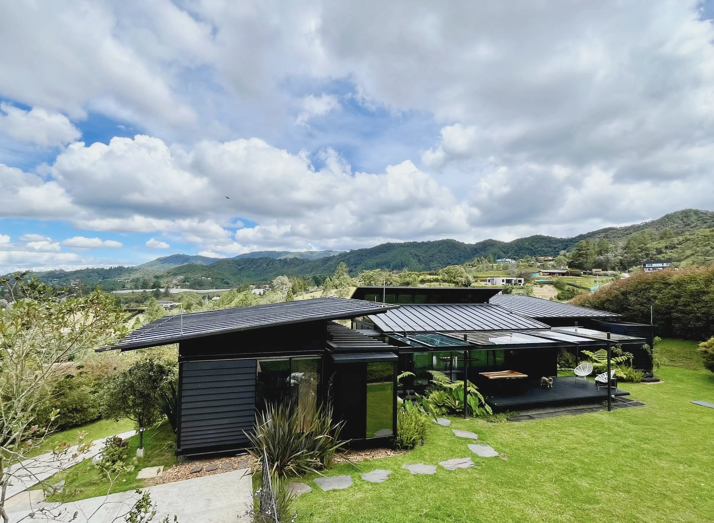 Aerial view of the house and the surrounding wooded hills