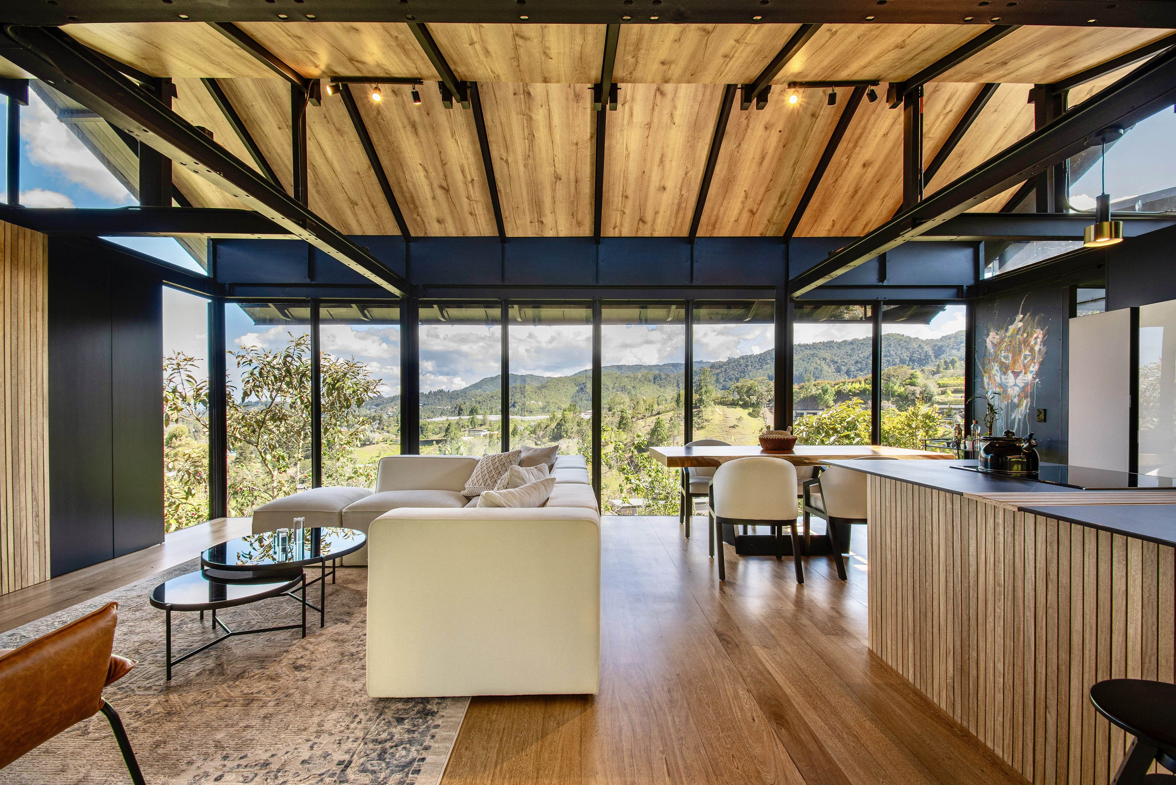 Open living and dining space beside a wood-clad kitchen island